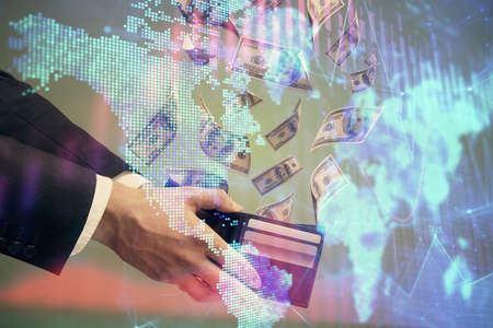 Multi exposure of financial graph drawing hologram and USA dollars bills and man hands. Analysis...
