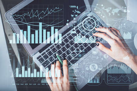 Double exposure of woman hands working on computer and forex chart hologram drawing. Top View....