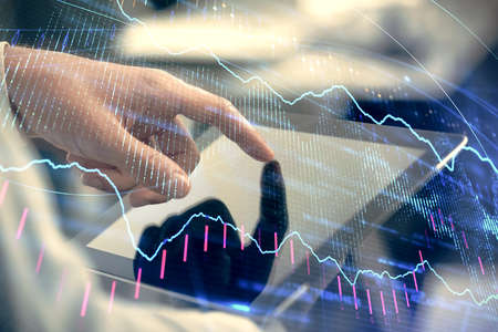 Multi exposure of mans hands holding and using a phone and financial chart drawing. Market analysis...