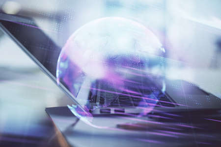 Computer on desktop in office with technology theme hologram. Double exposure. Tech concept.