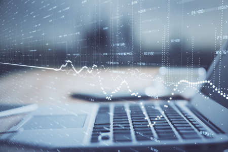 Financial chart drawing and table with computer on background. Multi exposure. Concept of...