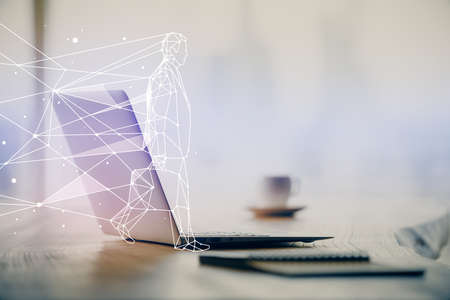 Desktop computer background in office and start up theme hologram drawing. Double exposure. Startup concept.の写真素材