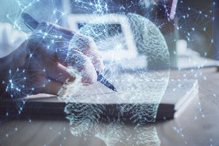 Multi exposure of writing hand on background with brain hologram. Concept of self learning.