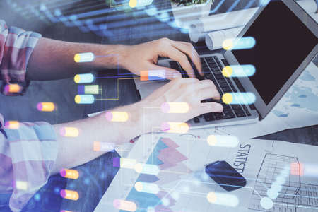 Multi exposure of technology hologram with man working on computer background. Concept of big data.