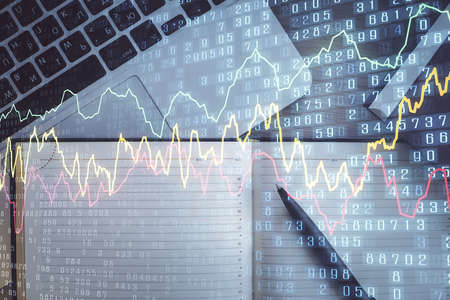 Stock market graph and top view computer on the table background. Multi exposure. Concept of...