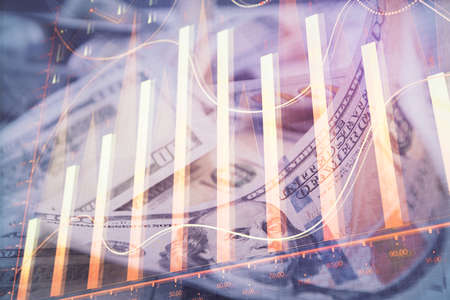 Double exposure of forex graph drawing over us dollars bill background. Concept of financial...