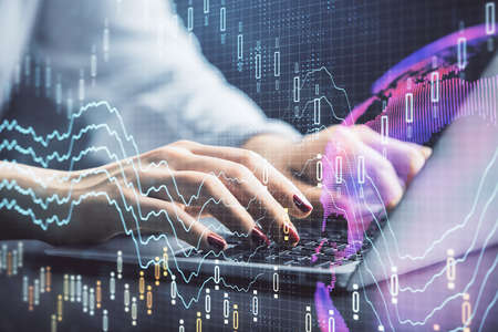 Double exposure of businesswoman hands typing on computer and forex chart hologram drawing....