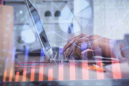 Double exposure of woman hands typing on computer and forex chart hologram drawing. Stock market...