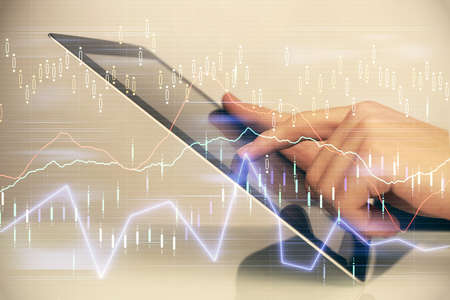 Multi exposure of mans hands holding and using a digital phone and forex graph drawing. Financial...