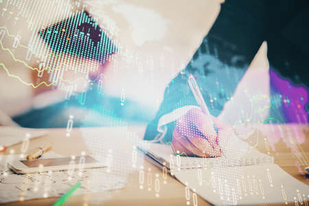 Double exposure of forex chart drawing over people taking notes background. Concept of financial...