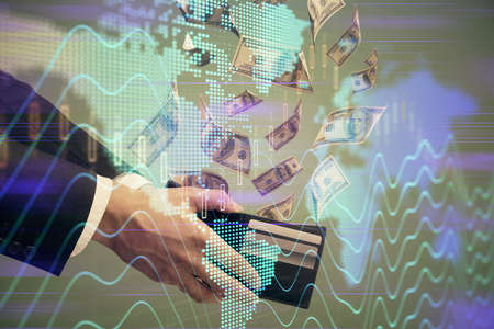 Multi exposure of financial graph drawing hologram and USA dollars bills and man hands. Analysis...