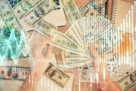 Multi exposure of financial graph drawing hologram and USA dollars bills and man hands. Analysis concept.の写真素材
