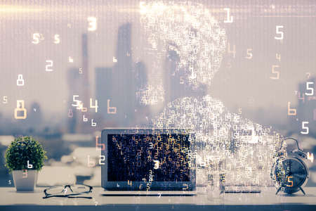 Computer on desktop in office with technology theme hologram. Double exposure. Tech concept.の写真素材