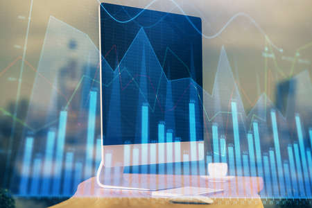 Financial chart drawing and table with computer on background. Multi exposure. Concept of...
