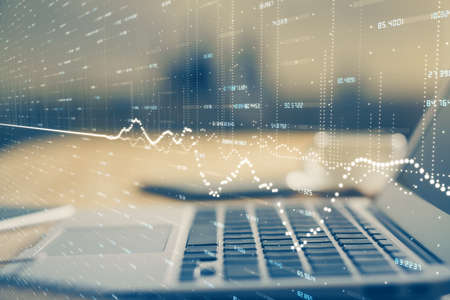 Double exposure of forex chart and work space with computer. Concept of international online trading.の写真素材