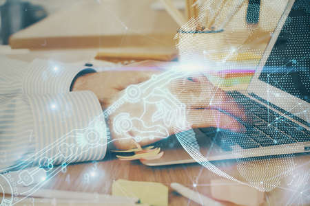 Technology theme hologram with man working on computer on background. High tech concept. Double...