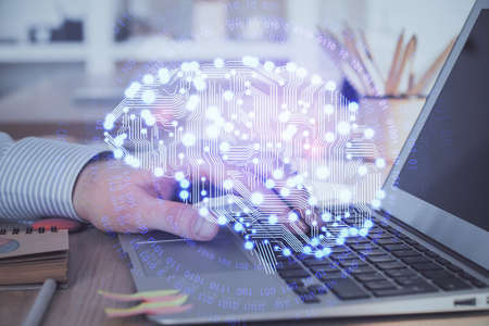Man typing on keyboard background with brain hologram. Concept of big Data. Double exposure.