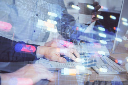 Double exposure of technology hologram with man working on computer background. Concept of big data.の写真素材