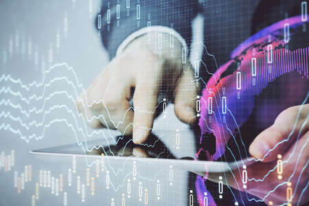 Multi exposure of mans hands holding and using a phone and financial chart drawing. Market analysis...