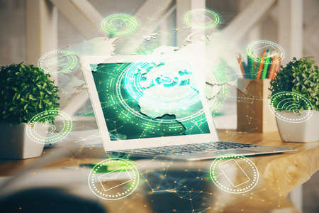 Computer on desktop with social network hologram. Double exposure. Concept of international people connections.の写真素材