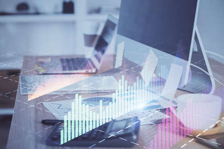 Forex market graph hologram and personal computer on background. Double exposure. Concept of...