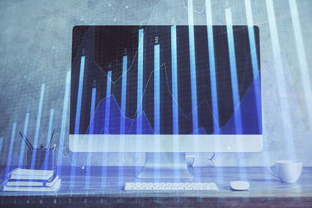 Forex Chart hologram on table with computer background. Double exposure. Concept of financial markets.の写真素材