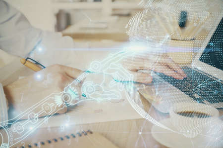 Technology theme hologram with man working on computer on background. High tech concept. Double...