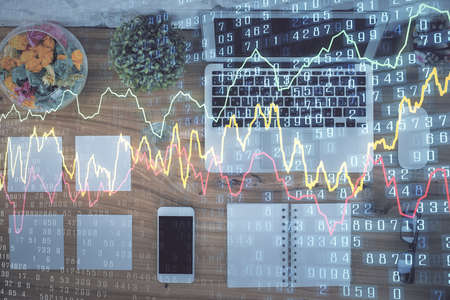Stock market graph and top view computer on the table background. Multi exposure. Concept of financial education.の写真素材