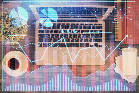 Stock market chart and top view computer on the table background. Multi exposure. Concept of...