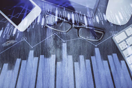 Multi exposure of forex graph hologram over desktop with phone. Top view. Mobile trade platform concept.の写真素材