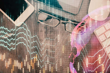 Multi exposure of forex graph hologram over desktop with phone. Top view. Mobile trade platform...