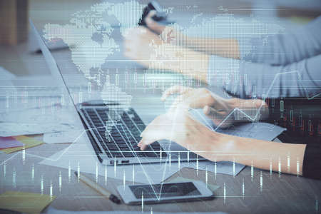 Multi exposure of woman hands typing on computer and financial chart hologram drawing. Stock market...