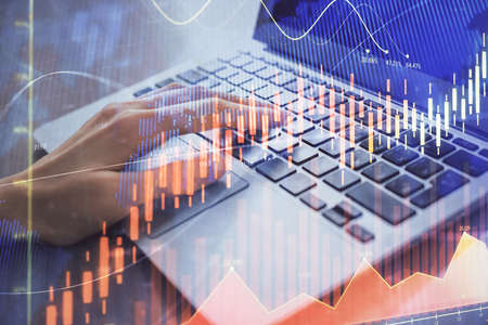 Double exposure of woman hands typing on computer and forex chart hologram drawing. Stock market...