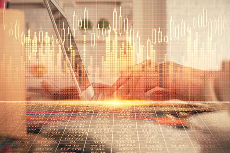 Double exposure of woman hands typing on computer and forex chart hologram drawing. Stock market...