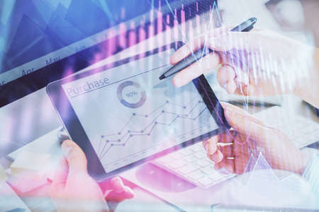 Double exposure of mans hands holding and using a phone and financial chart drawing. Market analysis...