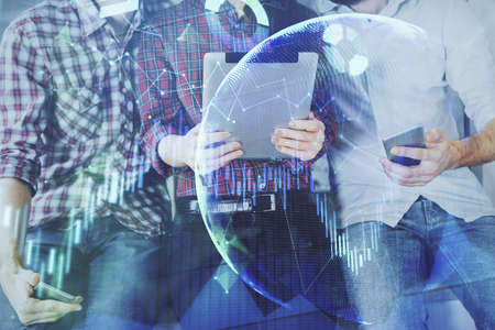 Double exposure of forex graph drawing and man and woman working together holding and using a mobile...