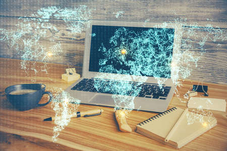 Computer on desktop with social network hologram. Double exposure. Concept of international people connections.の写真素材