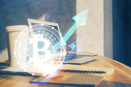 Double exposure of blockchain theme hologram and table with computer background. Concept of bitcoin crypto currency.の写真素材