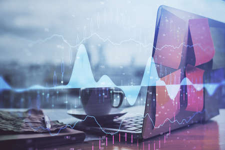 Forex market graph hologram and personal computer on background. Double exposure. Concept of...