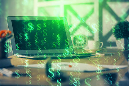 Forex market graph hologram and personal computer on background. Double exposure. Concept of investment.の写真素材