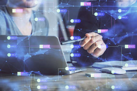Multi exposure of data internet theme hologram with man working on computer on background. Concept of innovation.の写真素材