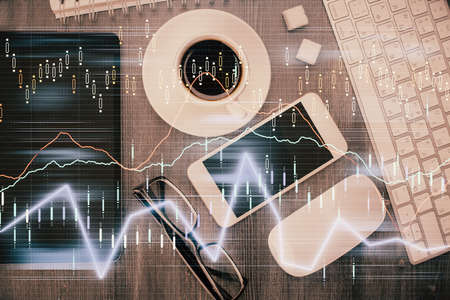 Multi exposure of forex graph hologram over desktop with phone. Top view. Mobile trade platform...