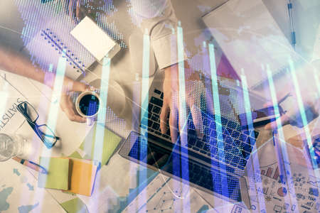 Double exposure of man and woman working together and forex graph hologram drawing. Financial analysis concept. Computer background. Top View.の写真素材