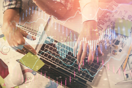 Double exposure of man and woman working together and forex graph hologram drawing. Financial...