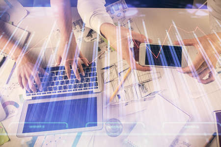 Multi exposure of man and woman working together and forex graph hologram drawing. Financial...