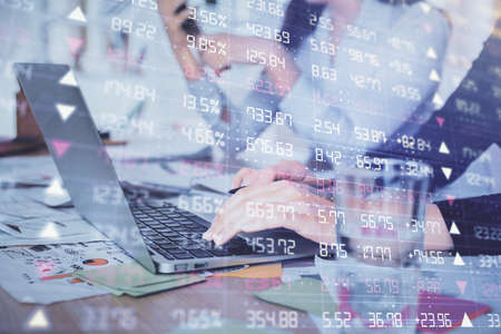 Multi exposure of woman hands typing on computer and forex chart hologram drawing. Stock market...