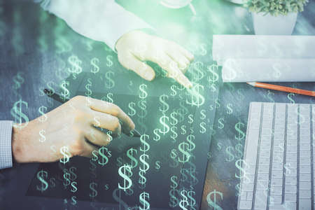 Double exposure of mans hands holding and using a phone and financial graph drawing. Analysis concept.の写真素材