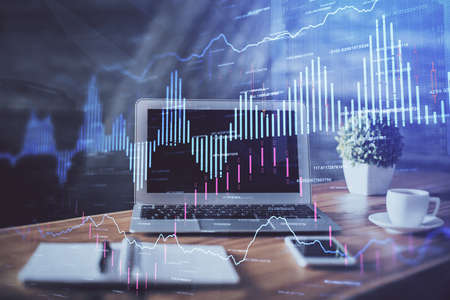 Financial graph colorful drawing and table with computer on background. Multi exposure. Concept of...