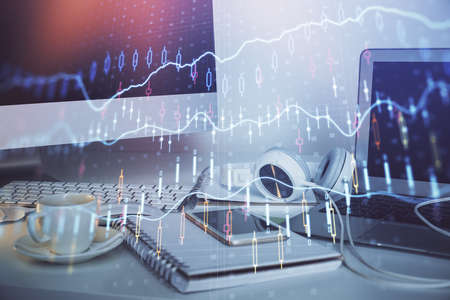 Forex market graph hologram and personal computer on background. Multi exposure. Concept of...