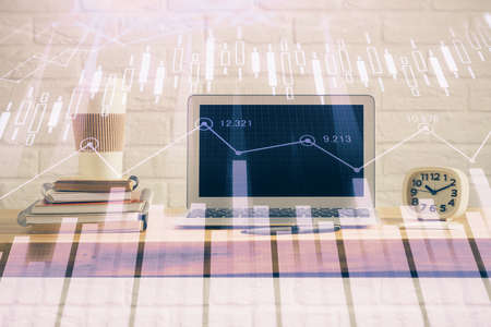 Forex market graph hologram and personal computer on background. Double exposure. Concept of investment.の写真素材